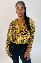 Load image into Gallery viewer, Front view of a size XL Cushnie 100% silk leopard print long sleeve bodysuit styled with black tapered slacks on a size 12 model.
