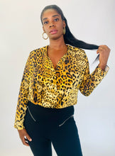 Load image into Gallery viewer, Additional front view of a size XL Cushnie 100% silk leopard print long sleeve bodysuit styled with black tapered slacks on a size 12 model.
