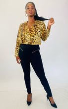 Load image into Gallery viewer, Additional full-body front view of a pair of size L A New Day black tapered slacks with zipper front pockets styled with a silky leopard print bodysuit and black pumps on a size 12 model.
