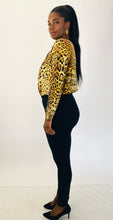Load image into Gallery viewer, Full-body side view of a pair of size L A New Day black tapered slacks with zipper front pockets styled with a silky leopard print bodysuit and black pumps on a size 12 model.
