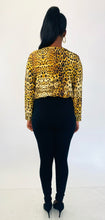 Load image into Gallery viewer, Full-body back view of a pair of size L A New Day black tapered slacks with zipper front pockets styled with a silky leopard print bodysuit and black pumps on a size 12 model.
