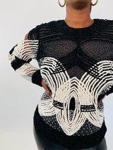 Load image into Gallery viewer, Close up detail shot of this size XL Naeem Khan black and white velvet, mesh, and beaded long sleeve blouse on a size 12 model.
