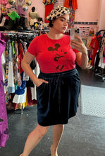 Load image into Gallery viewer, Front view of a size 0 Disney red Mickey Mouse cartoon graphic t-shirt with vintage-inspired distressing styled tucked into a navy blue velvet mini skirt and a leopard beret on a size 14/16 model.
