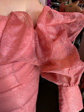 Load image into Gallery viewer, Close up view of the oversized ruffle bust and sleeve detail of size 24 ASOS peachy pink lace sheath dress with a corset-style bodice and oversized ruffle bust and sleeves with puff sleeves on a size 24 model. 
