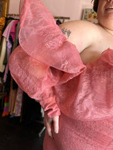 Load image into Gallery viewer, Close up view of the oversized ruffle bust and sleeve detail of size 24 ASOS peachy pink lace sheath dress with a corset-style bodice and oversized ruffle bust and sleeves with puff sleeves on a size 24 model.
