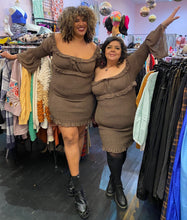 Load image into Gallery viewer, Additional full-body front view of a size 18 and a size 16 Pretty Little Thing neutral tone brown smocked-body off-shoulder-optional mini-midi dress with ruffle details and a bell sleeves styled with black shoes on a size 16/18 and 14/16 model, respectively.
