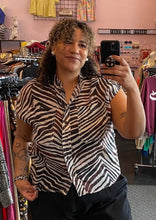 Load image into Gallery viewer, Front view of a size XL Banana Republic brown and cream zebra stripe print button-up shirt with breast pockets and no collar styled with black denim on a size 16/18 model.
