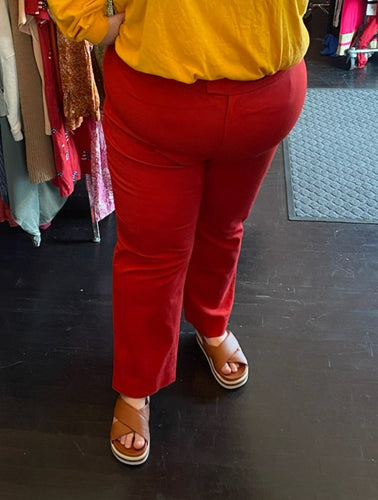 Front view of a pair of size 24W Anne Klein red trousers styled with brown slides on a size 24 model.