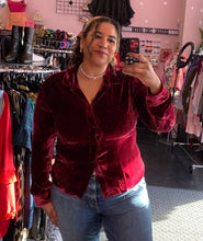 Load image into Gallery viewer, Additional front view of a size 18 JC Obando for 11 Honoré deep red crushed velvet collared button-up blouse styled with medium-lightwash denim on a size 16/18 model.
