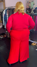 Load image into Gallery viewer, Full-body back view of a size XXXL Zelie for She bright red wide leg stretchy palazzo pant styled with a red turtleneck and black boots on a size 22/24 model.
