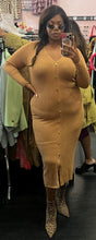 Load image into Gallery viewer, Additional full-body front view of a size XL Jeannie Mai x INC tan ribbed v-neck sweater dress with gold faux buttons and a small front slit styled with leopard boots on a size 14/16 model.
