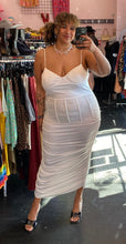 Load image into Gallery viewer, Full-body front view of a size 3X Finesse brand white ruched maxi dress with corset-style waist boning styled with black heels on a size 16/18 model.
