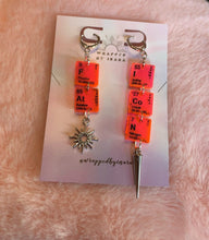 Load image into Gallery viewer, Additional close up of the pink &amp; silver colorway of these Wrapped By Inara &quot;FAT ICON&quot; elemental earrings with a little sun charm and a needle charm on either earring.
