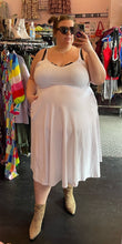 Load image into Gallery viewer, Full-body front view of a size 3X Rebdolls white a-line midi tank dress styled with black sunglasses and leopard booties on a size 24 model.
