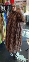 Load image into Gallery viewer, Full-body side view of a size 26 Wednesday&#39;s Girl by ASOS pink, brown, white, and black leopard pattern high-neck maxi dress with smocking at the neck styled with black boots on a size 20/22 model.
