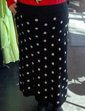 Load image into Gallery viewer, Close up front view of a size 2X Victor Glemaud x Target black and white polka dot sweater maxi skirt on a size 20/22 model.
