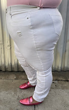 Load image into Gallery viewer, Side view of a pair of size 24 Fashion to Figure slight high-waisted white distressed denim with the distressing focused at the knee and shins styled with a pink tee and pink loafers on a size 24/26 model.
