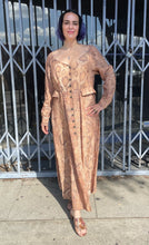 Load image into Gallery viewer, Additional full-body front view of a size 12 Mara Hoffman tan, brown, and white snake print button-up maxi dress with hip pocket details styled with snake print heels on a size 10 model. The photo is taken outside in natural lighting.
