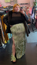 Load image into Gallery viewer, Full-body front view of a size 3X Fashion Nova green and white acid wash tie-dye maxi skirt with high high side slit and mini skirt lining styled with a black mesh-detail crop and fur jacket on a size 22/24 model.
