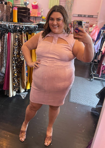 Full-body front view of a size 3 Fashion to Figure baby pink suede sheath dress with bust cut-outs styled with brown heels on a size 18/20 model.