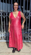 Load image into Gallery viewer, Additional full-body front view of a size 14 Dima Ayaad grapefruit pink colored v-neck gown with big sequins all throughout styled with black combat boots on a size 10 model. The photo is taken outside in natural lighting.
