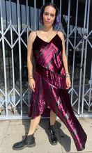 Load image into Gallery viewer, Additional full-body front view showing off the asymmertical hem of a size 12 Parker NY for 11 Honoré maroon-purple velvet shift midi dress with asymmertical handkerchief hemline styled with combat boots on a size 10 model. The photo is taken outside in natural light.
