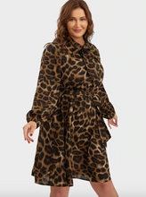 Load image into Gallery viewer, Additional front view of a size 12 Bloomchic brown and black leopard print a-line midi dress with long sleeves, bussy bow, and tie delt on a size 14 model.
