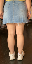 Load image into Gallery viewer, Back view of a size 1X SHEIN light wash paperbag waist denim mini skirt styled with a yellow off the shoulder top and white sneakers on a size 12 model.
