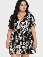 Load image into Gallery viewer, Front view of a black, white, and cream floral mini dress with ruffles at the sleeves.
