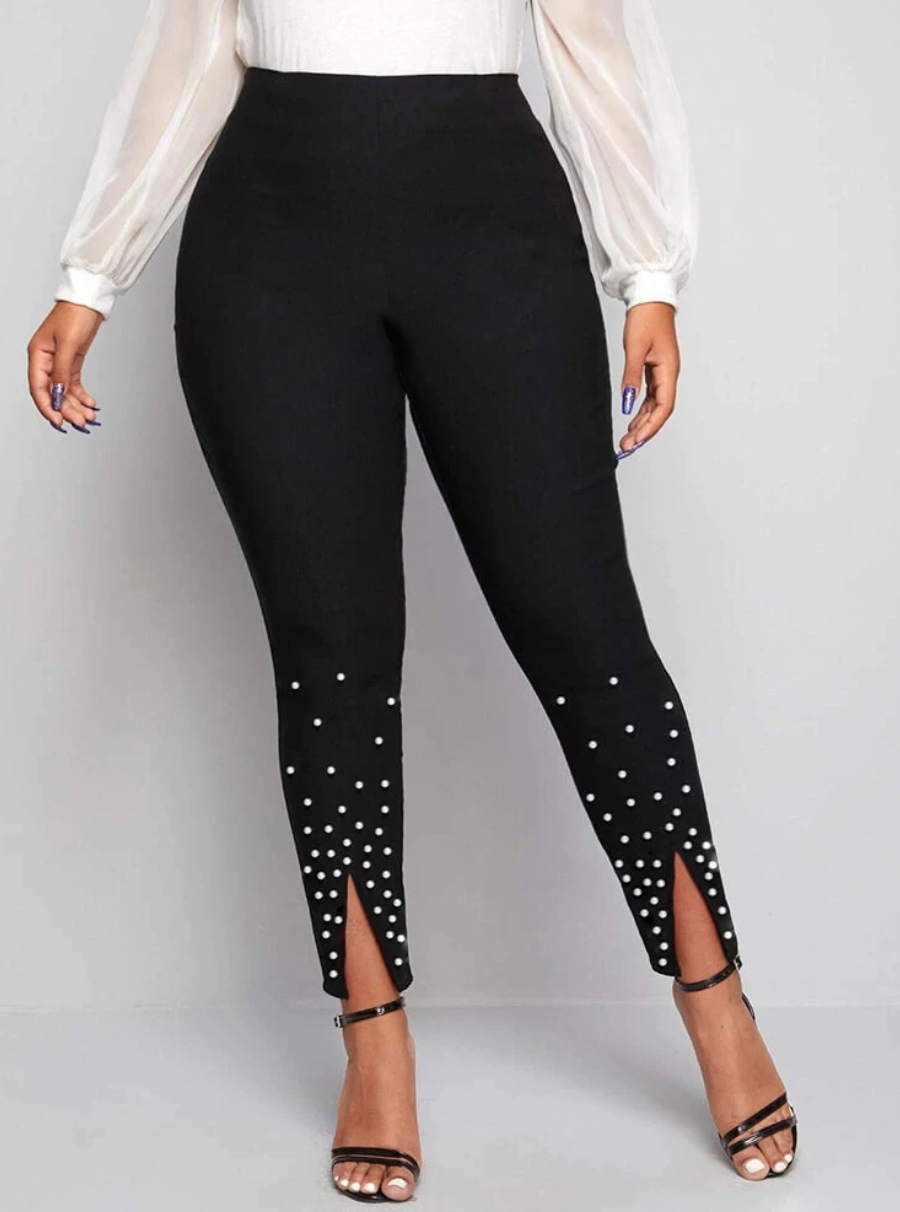 Front view of a pair of black leggings with white beading at the lower leg and front slits.