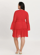 Load image into Gallery viewer, Full-body back view of a Bloomchic bright red plunge-neckline red chiffon ruffle-tiered midi dress.
