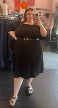 Load image into Gallery viewer, Additional full-body front view of a size 22/24 Beauticurve x Lane Bryant collab black off-the-shoulder midi dress styled with a black and gold snake belt and a pearl headband on a size 24 model.

