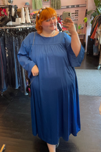 Load image into Gallery viewer, Full-body front view of a size 3X Amazon The Drop x Kellie B collaboration royal blue caftan maxi dress styled with a pearl headband on a size 22/24 model.
