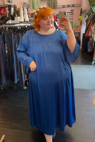Full-body front view of a size 3X Amazon The Drop x Kellie B collaboration royal blue caftan maxi dress styled with a pearl headband on a size 22/24 model.