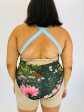 Load image into Gallery viewer, Back view of a size 2X WRAY one piece swimsuit with a ruched detail in the middle on a size 18/20 model.
